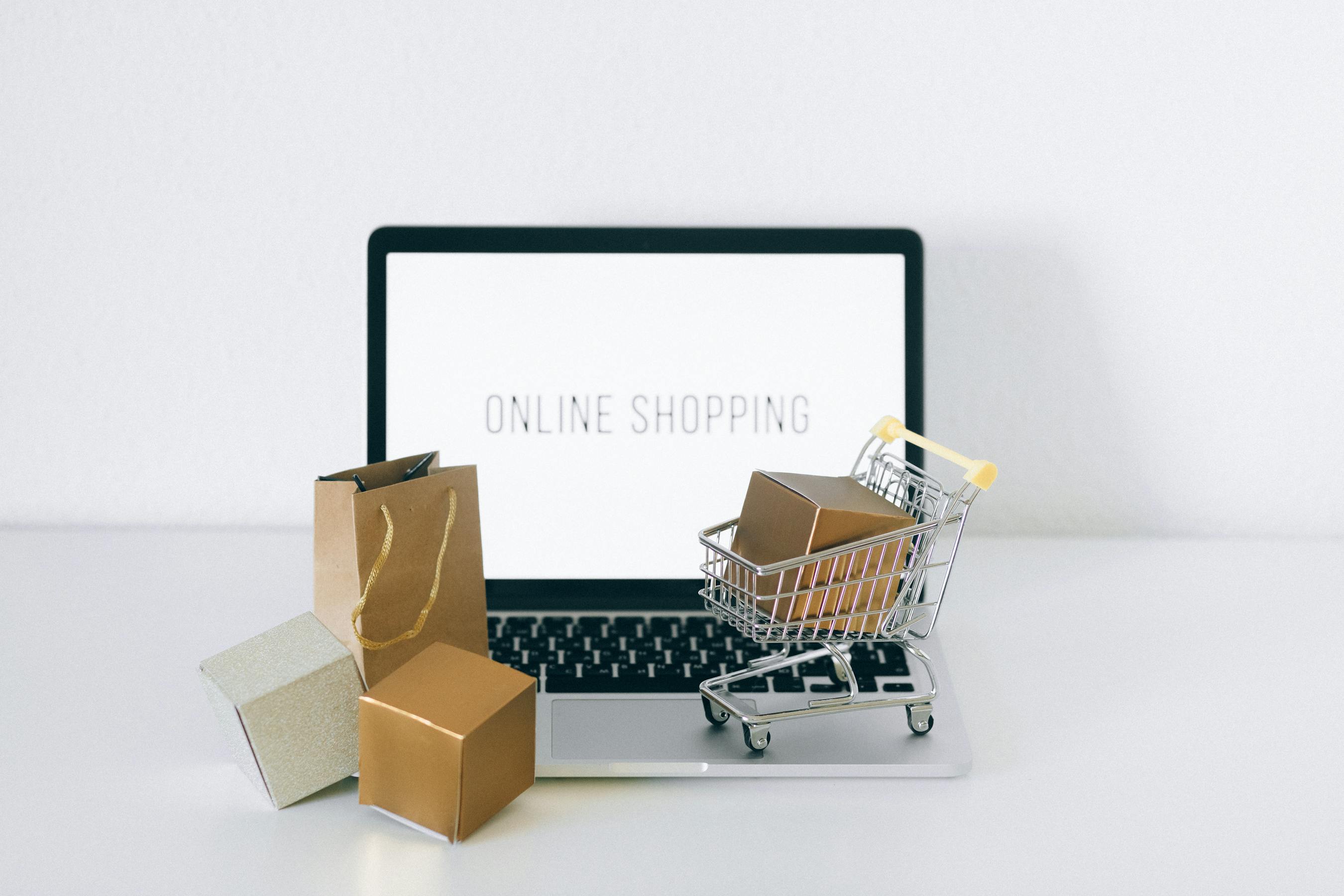 Ecommerce shopping cart and packages on a laptop